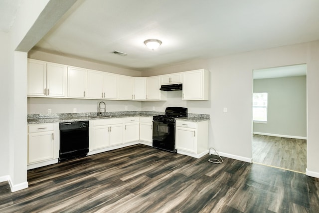 kitchen featuring black appliances, light stone countertops, white cabinetry, and sink