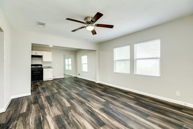 unfurnished living room with ceiling fan and dark hardwood / wood-style floors