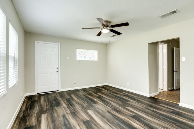 spare room featuring ceiling fan and dark hardwood / wood-style floors