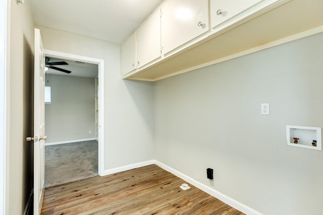 clothes washing area with light hardwood / wood-style floors, ceiling fan, cabinets, and washer hookup