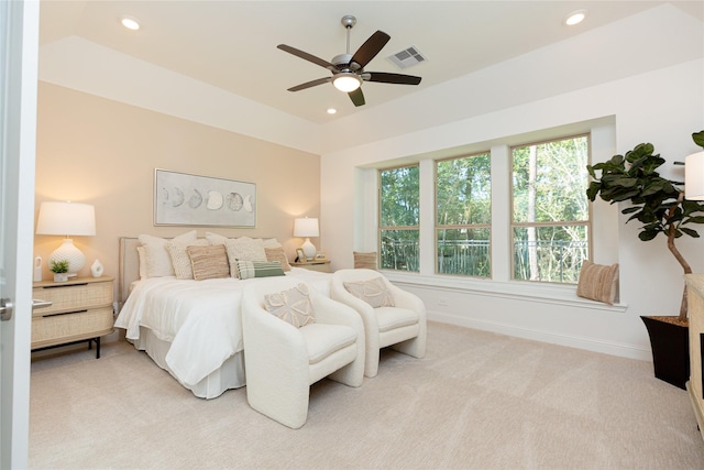 bedroom with a tray ceiling, ceiling fan, and light colored carpet