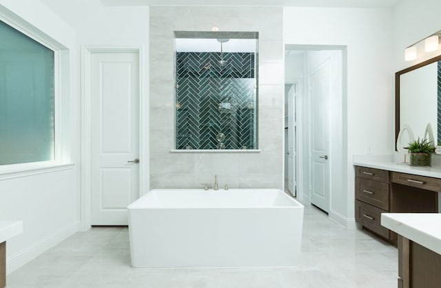 bathroom featuring tile patterned flooring, vanity, and plus walk in shower