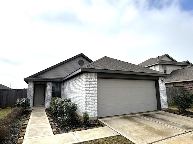 view of front of home featuring a garage, fence, concrete driveway, and brick siding