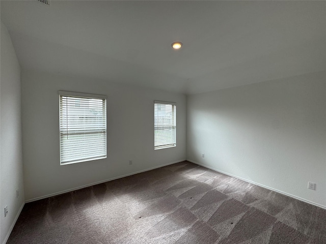 carpeted empty room with a healthy amount of sunlight