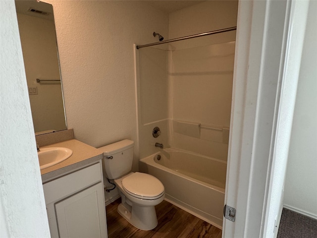 full bathroom featuring hardwood / wood-style floors, vanity, toilet, and bathtub / shower combination