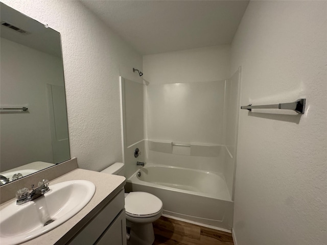 full bathroom with hardwood / wood-style floors, vanity, toilet, and tub / shower combination