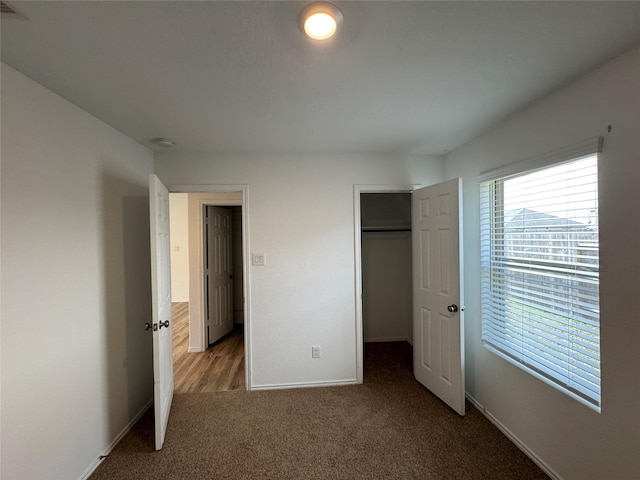 unfurnished bedroom featuring a closet and carpet floors