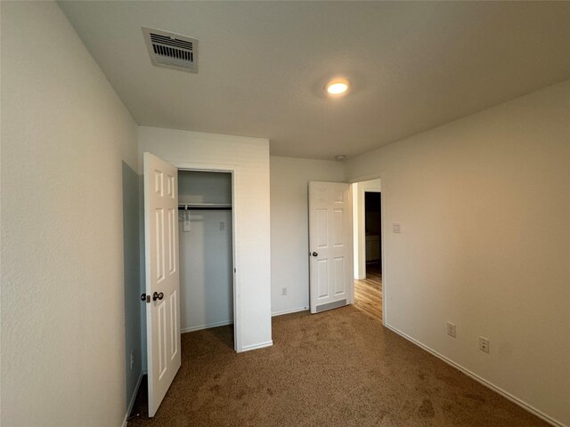 unfurnished bedroom featuring a closet and carpet