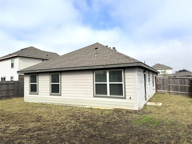 back of house with a lawn