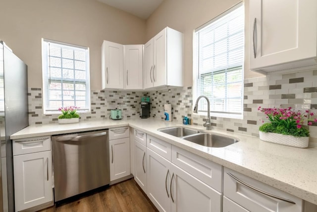 kitchen with white cabinetry, dishwasher, sink, dark hardwood / wood-style floors, and decorative backsplash