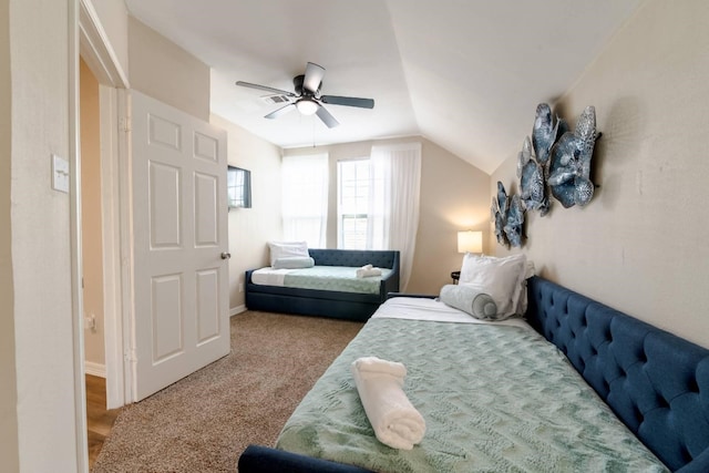 bedroom featuring carpet, ceiling fan, and vaulted ceiling