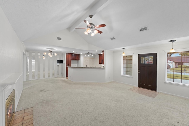 unfurnished living room featuring vaulted ceiling with beams, ceiling fan with notable chandelier, and light colored carpet