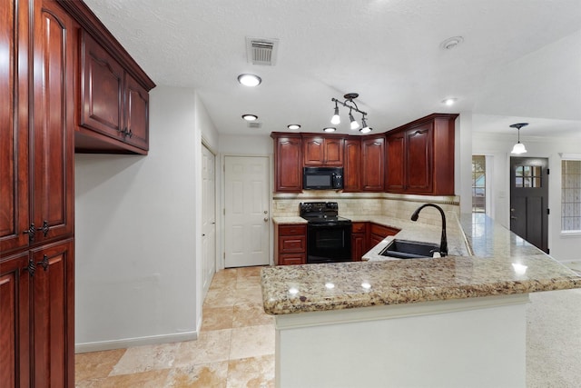 kitchen with kitchen peninsula, light stone countertops, sink, black appliances, and decorative light fixtures