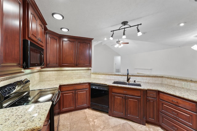 kitchen with lofted ceiling, black appliances, sink, decorative backsplash, and light stone counters