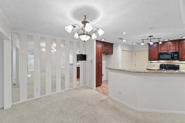 kitchen featuring an inviting chandelier, light stone counters, backsplash, crown molding, and black appliances