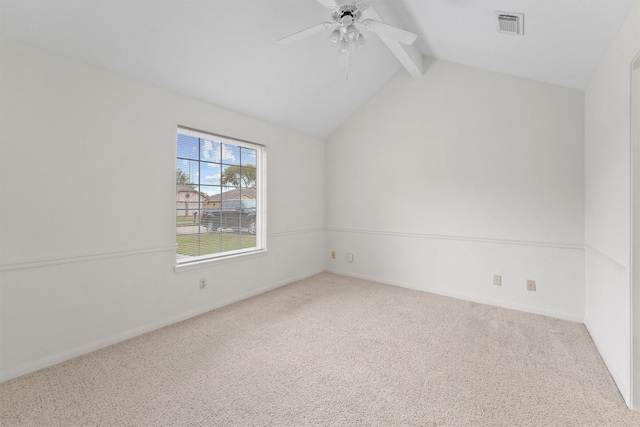 carpeted spare room with ceiling fan and lofted ceiling with beams