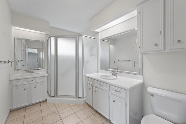 bathroom with toilet, vanity, tile patterned floors, and an enclosed shower