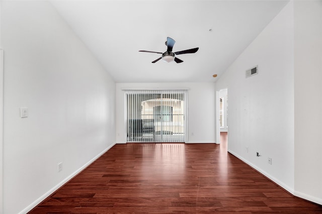 unfurnished room with dark hardwood / wood-style flooring, vaulted ceiling, and ceiling fan