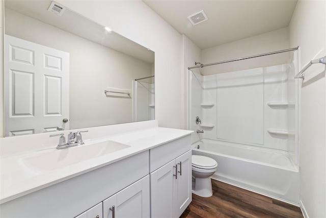 full bathroom with wood-type flooring, vanity, toilet, and shower / washtub combination