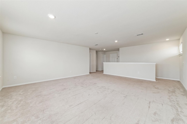 unfurnished room with light carpet