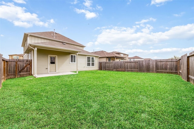 back of property with a lawn and a patio area