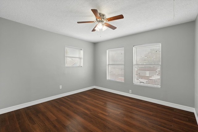 spare room featuring ceiling fan, dark wood-type flooring, and a textured ceiling