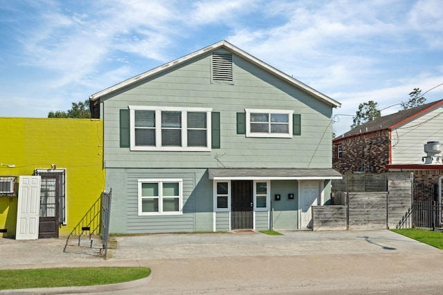 view of front of property featuring fence and driveway