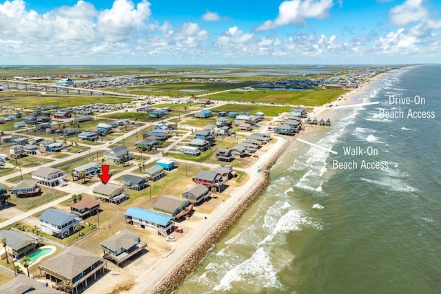 aerial view featuring a water view and a beach view