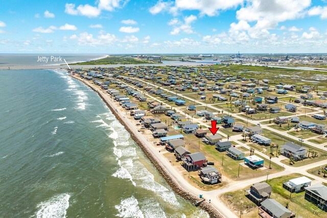 drone / aerial view with a water view and a view of the beach