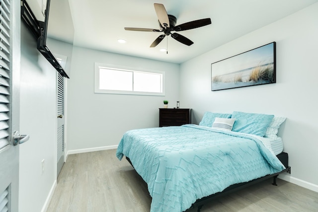 bedroom with ceiling fan and light hardwood / wood-style flooring