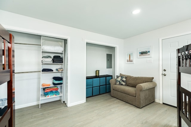 interior space with electric panel and light hardwood / wood-style flooring