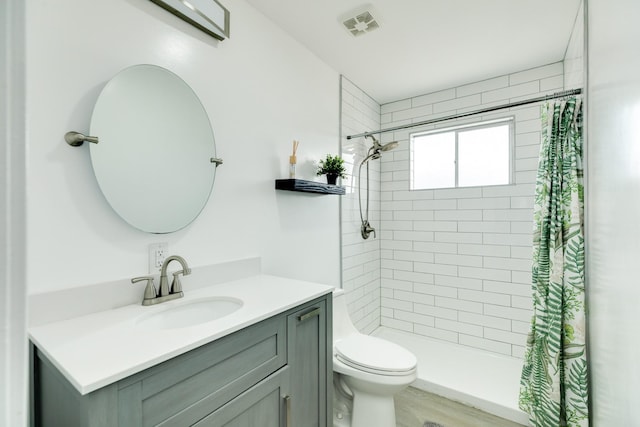 bathroom featuring hardwood / wood-style floors, vanity, toilet, and walk in shower