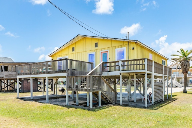 rear view of property with a lawn and a wooden deck