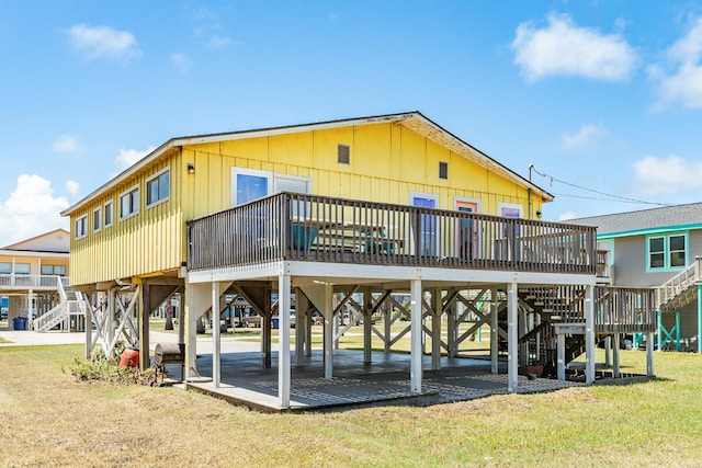 rear view of property with a yard and a deck