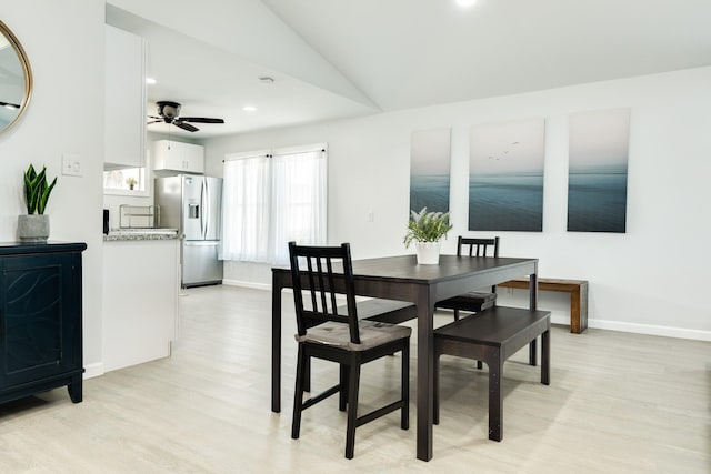 dining space featuring light hardwood / wood-style flooring, ceiling fan, and lofted ceiling