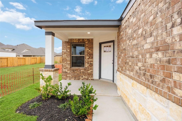 doorway to property with a yard