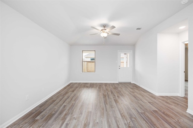 spare room featuring ceiling fan, wood-type flooring, and vaulted ceiling