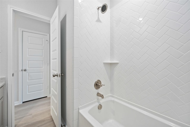 bathroom featuring vanity, tiled shower / bath combo, and hardwood / wood-style flooring