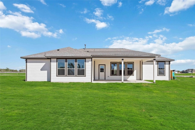 back of house with a patio area and a yard