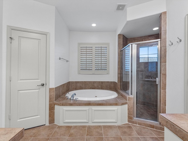 bathroom featuring tile patterned floors and separate shower and tub