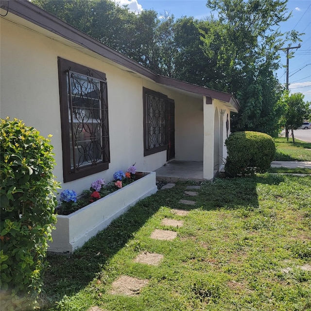 view of property exterior featuring a lawn