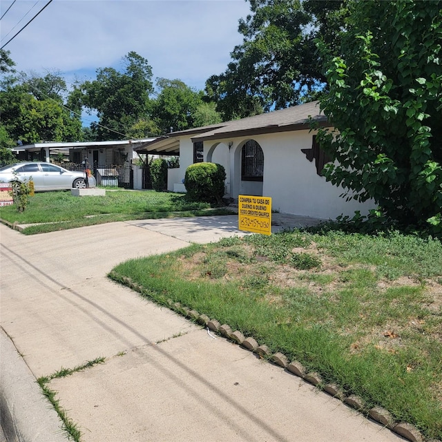 single story home with a carport and a front lawn