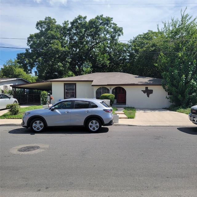 ranch-style house featuring a carport