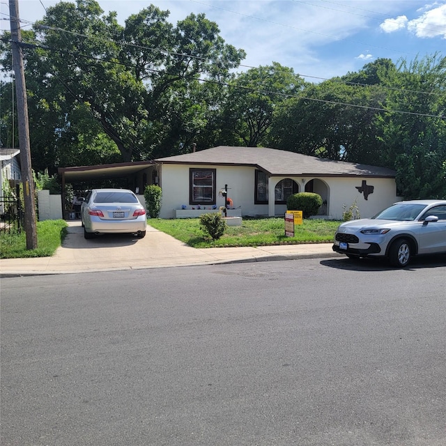 single story home featuring a carport