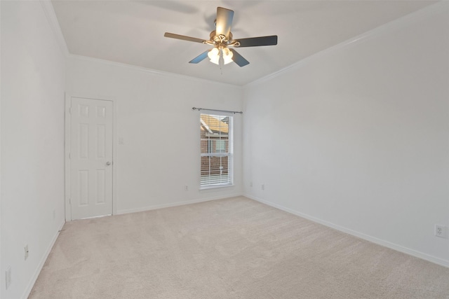 empty room with light carpet, ceiling fan, and crown molding