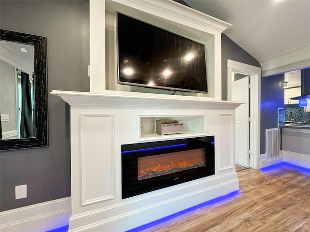 interior details featuring tasteful backsplash, hardwood / wood-style flooring, and ornamental molding