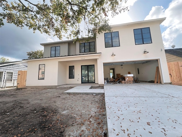 back of house featuring a patio area and a garage