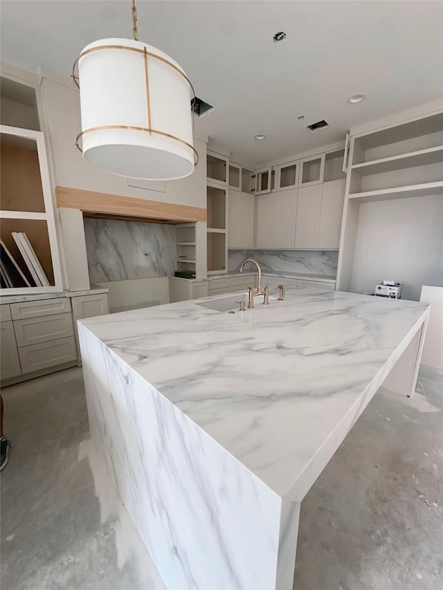 kitchen with pendant lighting, a center island, and sink