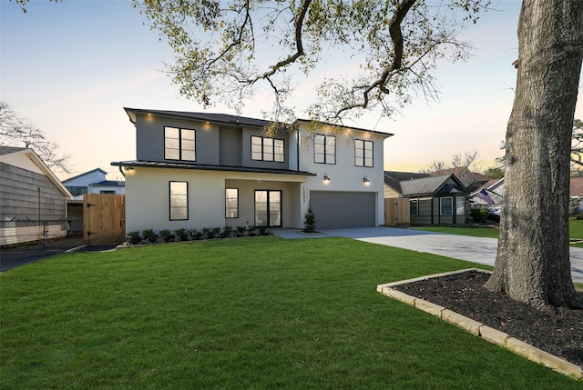 view of front of home featuring stucco siding, a front lawn, fence, concrete driveway, and a garage