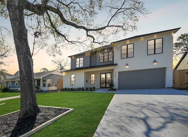 view of front of home featuring concrete driveway, metal roof, a standing seam roof, and a front yard